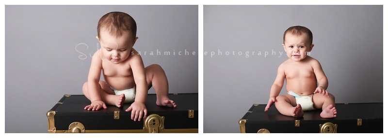 baby in diaper on black trunk 
